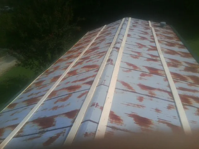 Rusted metal roof panels with new wood purlins before replacement — Storm Damage Roof Repair in Mountain View by Roofing Brothers