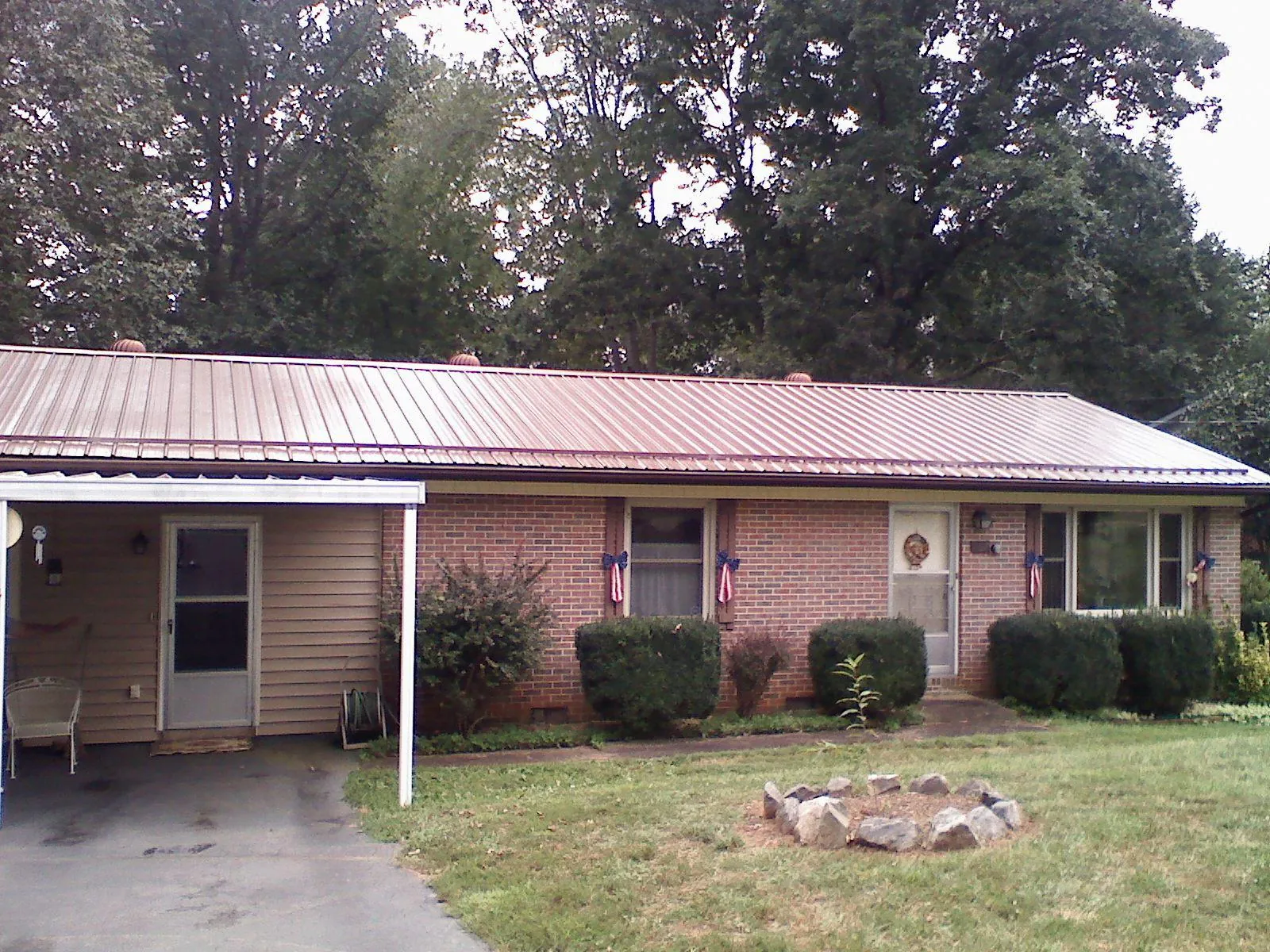 Bronze metal roof and carport on a brick ranch home — Roof Repair work by our crew in Mountain View